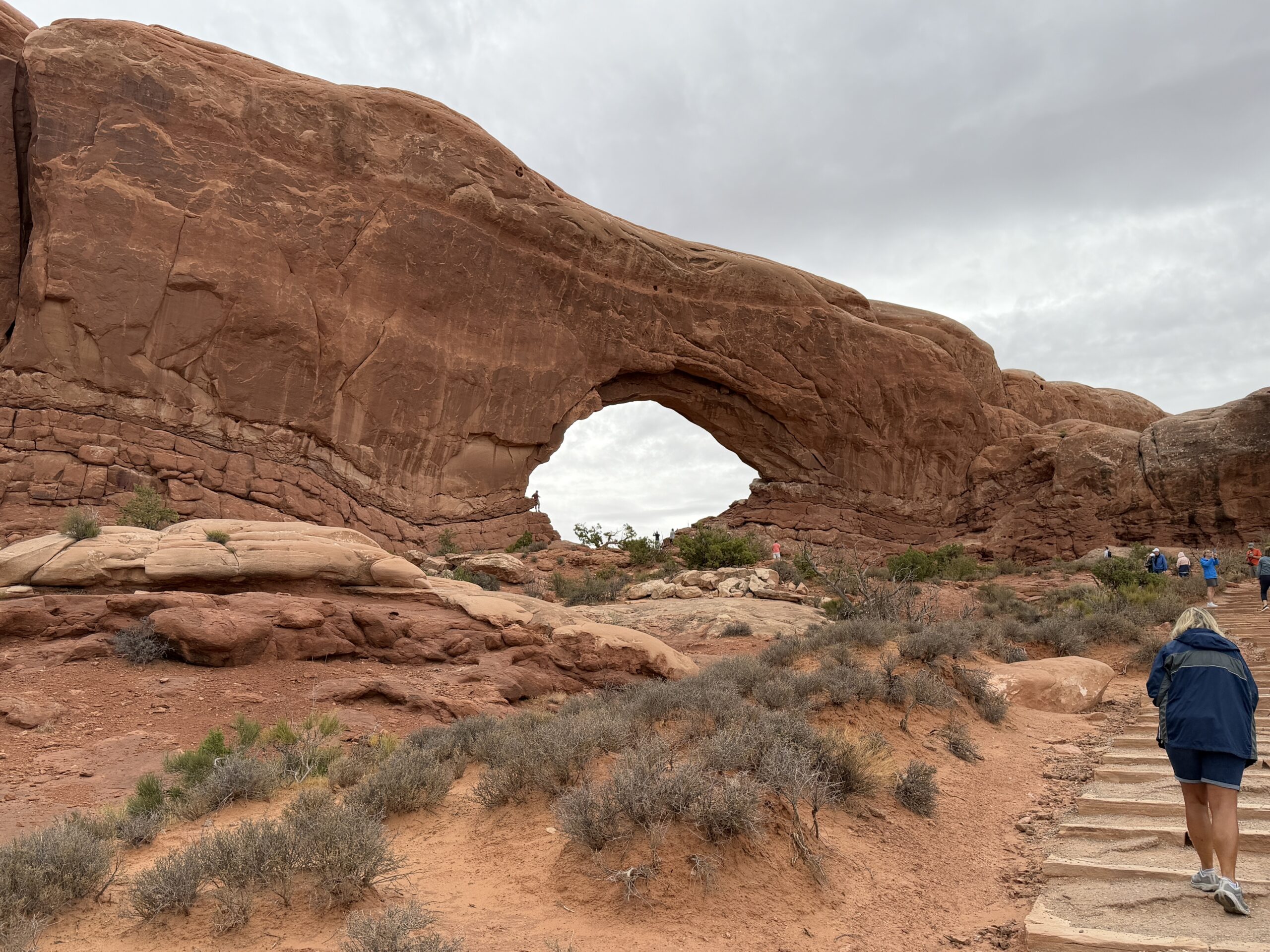 A natural arch and trail in Arches National Park.