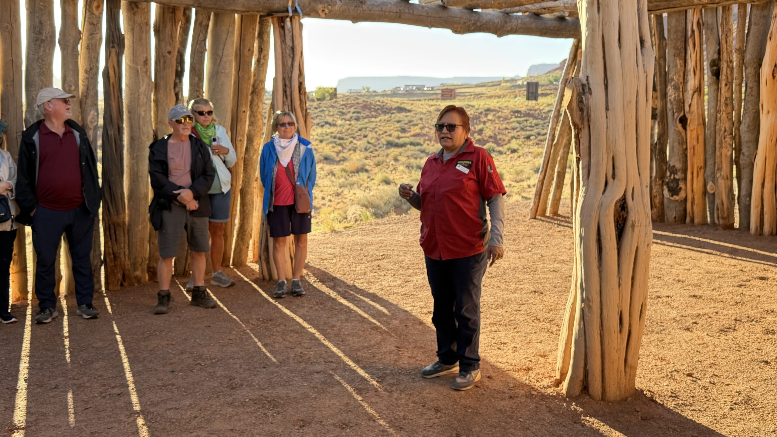 Helen in a red shirt explains the timber structure to our group.