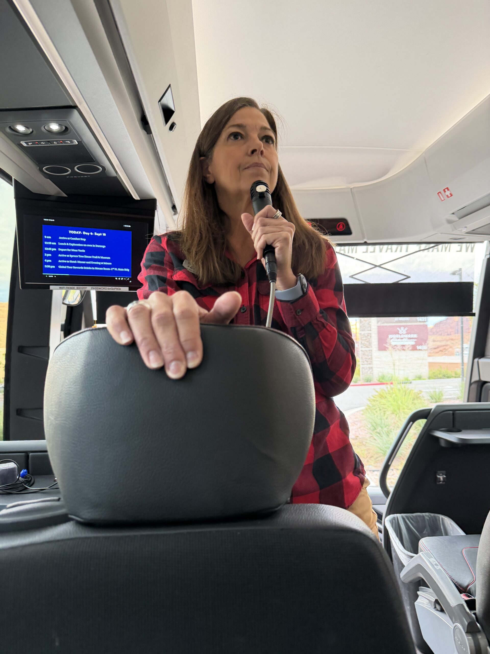 Jenn Andres, our Insight Travel Director, speaks to the group aboard the coach.