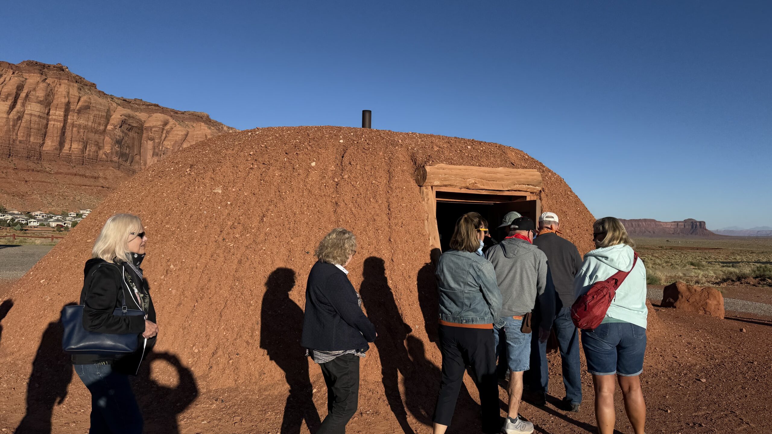 Our group enters the rounded, earth-covered hogan.